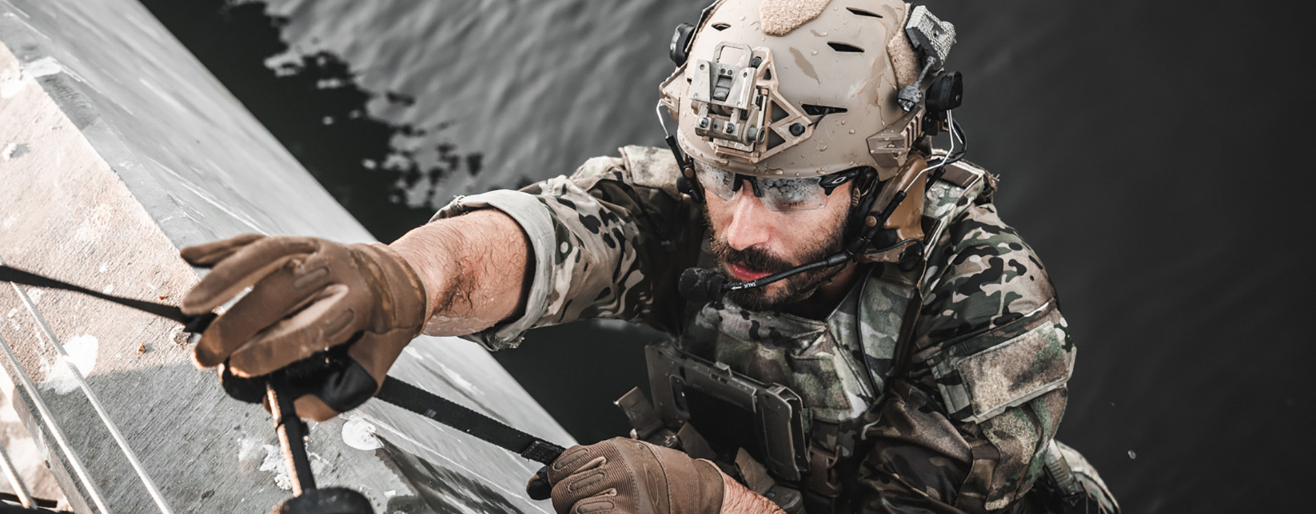 Man in camo and helmet abseiling