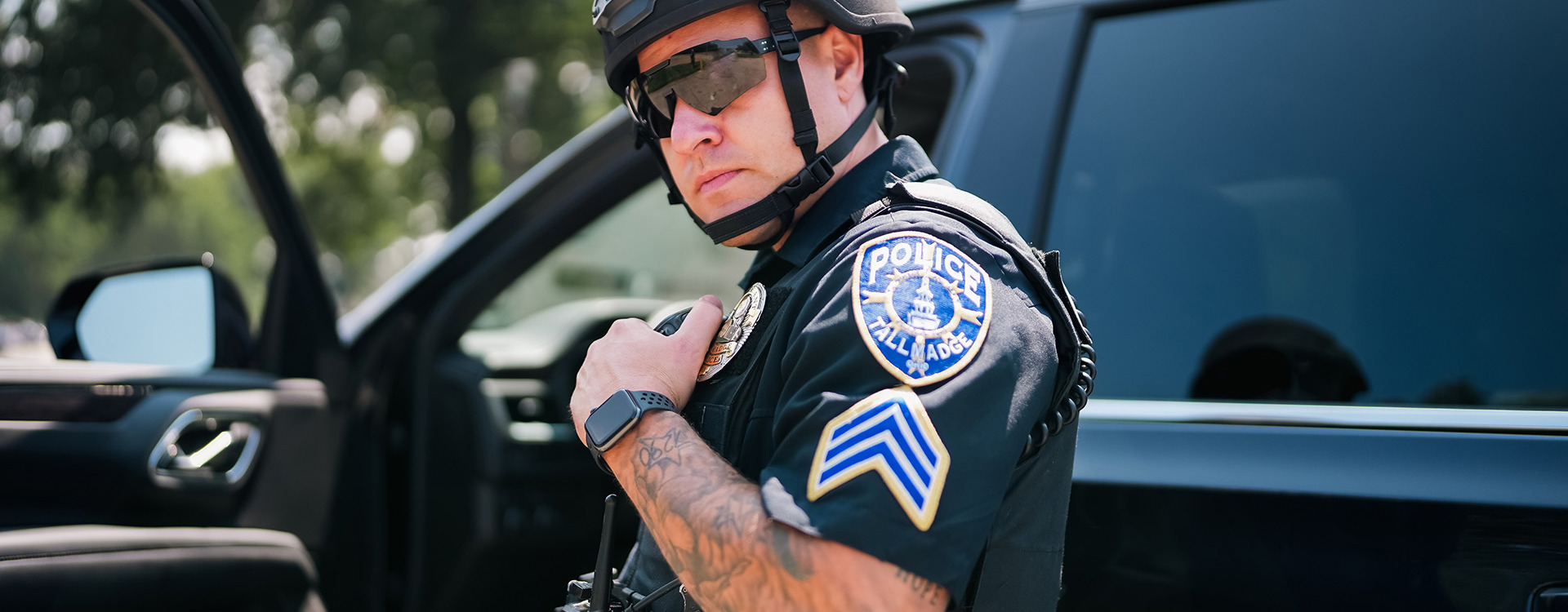 Policeman in helmet talking into radio