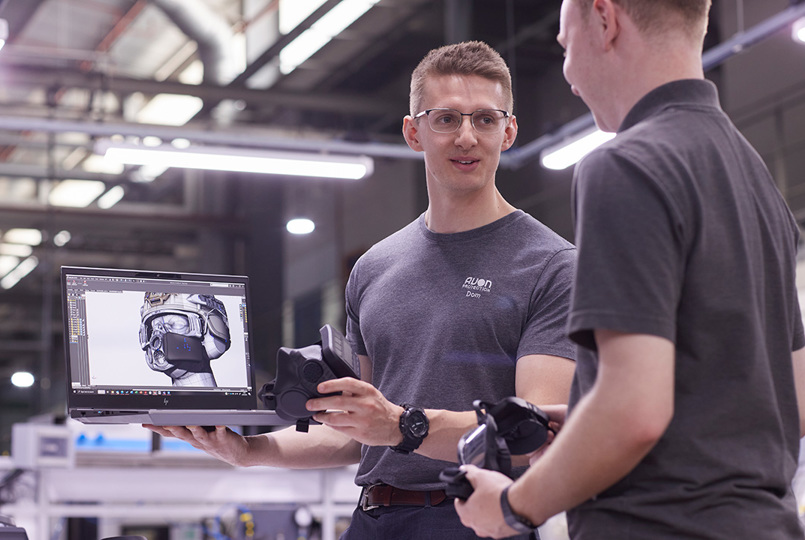 Two employees looking at an Avon Protection MITR Half Mask design on a laptop