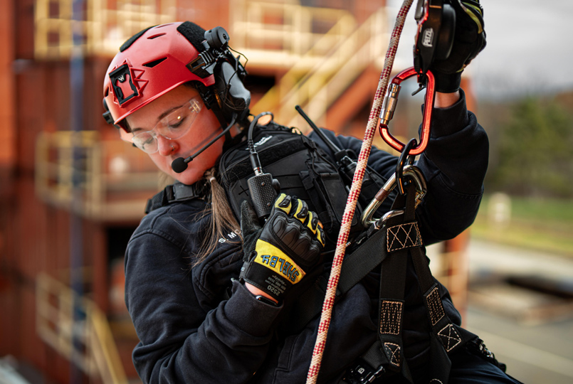Woman in protective gear absailing