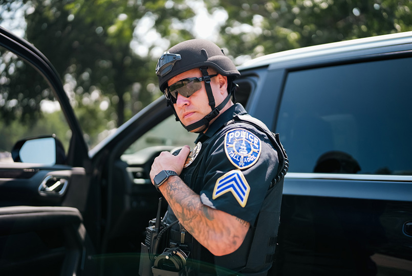 Policeman in helmet talking into radio