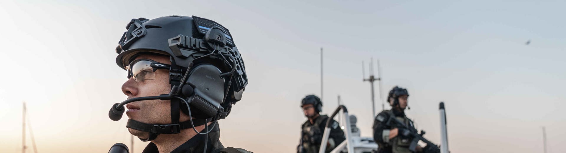 Employee quality checking a helmet part