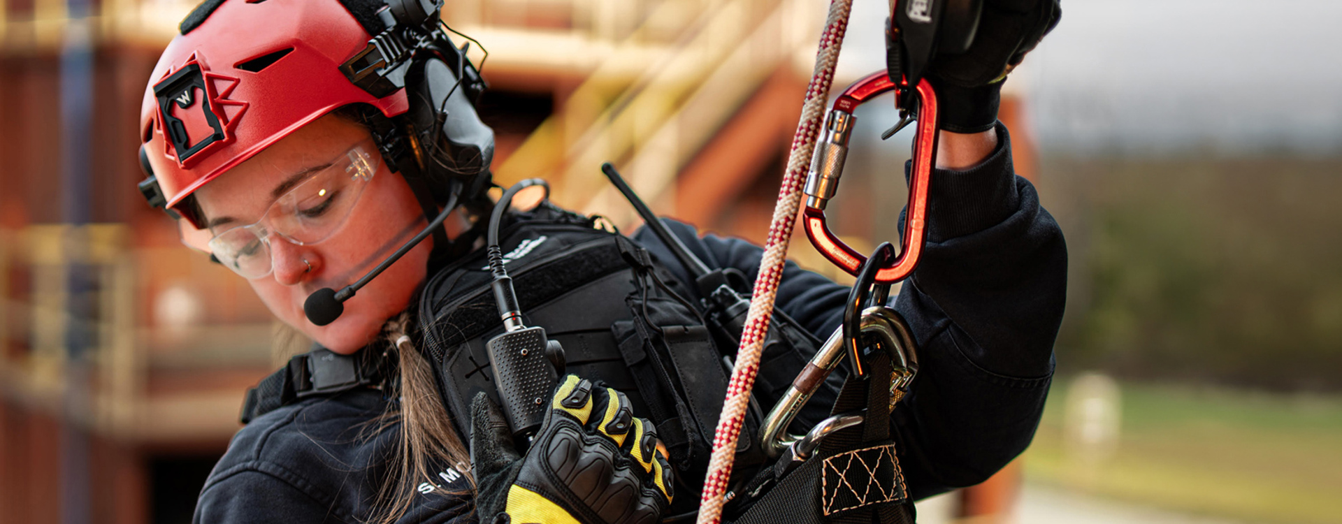 Woman in protective gear abseiling