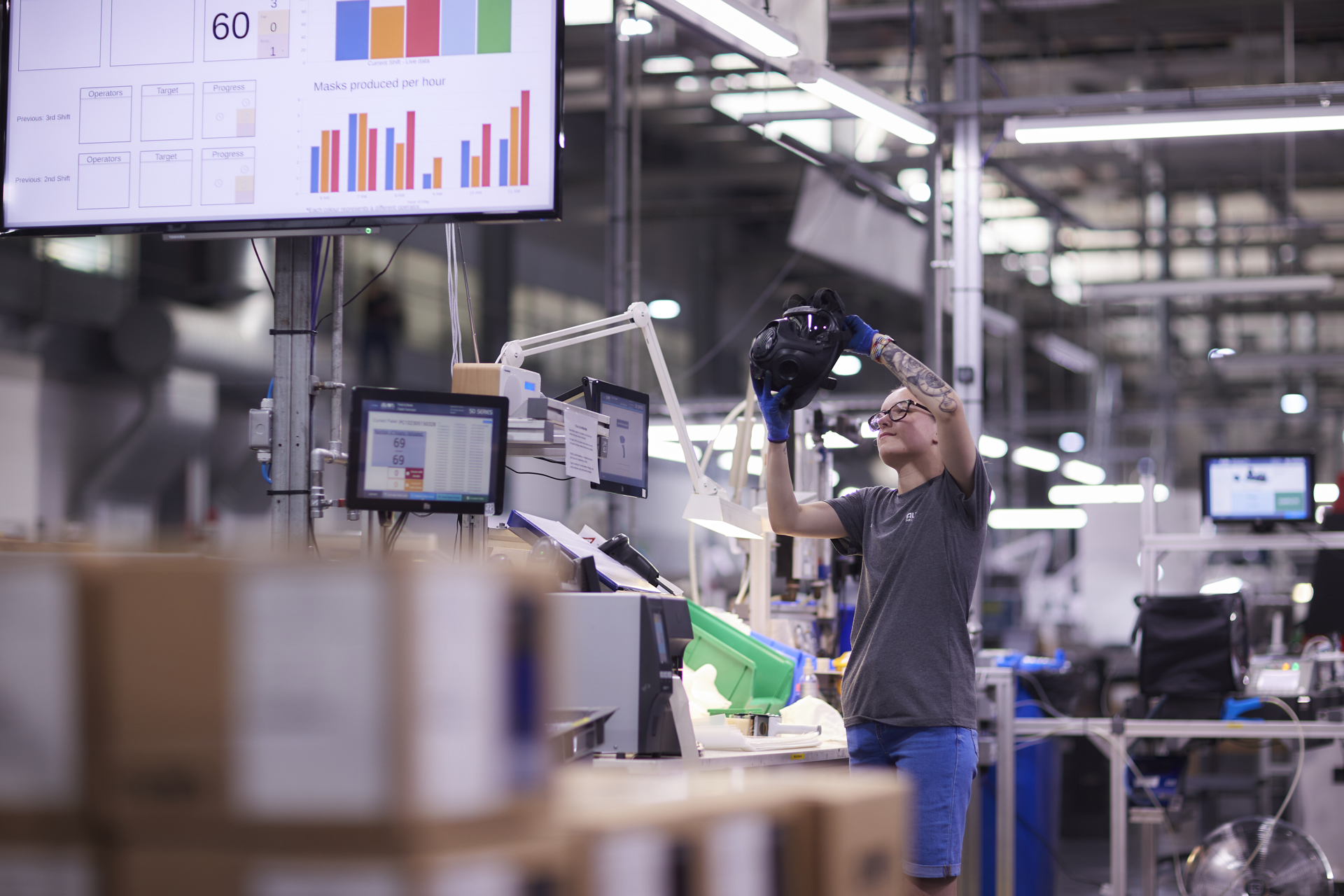 Two employees gathered around a screen